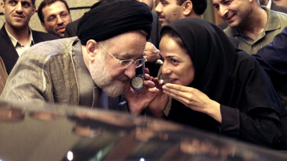 Iranian President Mohammad Khatami talks on the phone with the mother of female journalist Masih Alinejad, right