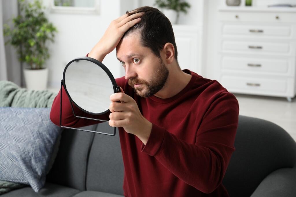Man,With,Hair,Loss,Problem,Looking,At,Mirror,Indoors